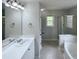 Bright and clean bathroom with a double sink, vanity, and separate shower and tub, providing luxury at 312 Sarazen Dr, Clayton, NC 27527