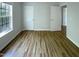 Well-lit room features wood-look floors, a large window, and multiple entryways at 312 Sarazen Dr, Clayton, NC 27527