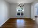 Elegant dining area boasts hardwood floors, natural light, and chandelier at 312 Sarazen Dr, Clayton, NC 27527