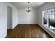 Classic dining room with hardwood floors, chandelier, and large window, setting an elegant mood at 312 Sarazen Dr, Clayton, NC 27527