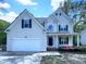 Charming two-story home with landscaped front yard, attached garage, and inviting front porch at 312 Sarazen Dr, Clayton, NC 27527