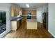 Well-equipped kitchen with stainless steel appliances, wood cabinets, and an island, great for cooking at 312 Sarazen Dr, Clayton, NC 27527