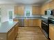 Functional kitchen boasting wood cabinets, stainless steel appliances, a kitchen island and hardwood floors at 312 Sarazen Dr, Clayton, NC 27527