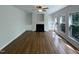 Bright living room featuring a fireplace, built-in shelves, hardwood floors, and large windows at 312 Sarazen Dr, Clayton, NC 27527
