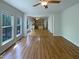 Open-concept living room with hardwood floors, large windows, and open access to the kitchen at 312 Sarazen Dr, Clayton, NC 27527