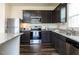 Modern kitchen with stainless steel appliances, granite counters, dark cabinets and wood floors at 3521 Strawberry Patch Row, Raleigh, NC 27604