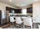 Modern kitchen with stainless steel appliances, granite counters, and an island with bar stool seating at 3521 Strawberry Patch Row, Raleigh, NC 27604