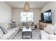 Bright living room with a large window, comfortable seating, and contemporary decor at 3521 Strawberry Patch Row, Raleigh, NC 27604