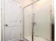 Modern bathroom featuring a glass-enclosed shower and a white door at 3521 Strawberry Patch Row, Raleigh, NC 27604