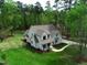 Aerial shot of a two-story home on a large manicured lawn bordered with mature trees at 3881 Whisperwood Ct, Youngsville, NC 27596