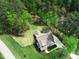Aerial view of a stunning home surrounded by lush greenery and mature trees, showcasing privacy and tranquility at 3881 Whisperwood Ct, Youngsville, NC 27596