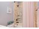 Clean bathroom with tiled shower, tub, and vanity with a round mirror at 3881 Whisperwood Ct, Youngsville, NC 27596