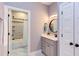 Stylish bathroom boasts gray vanity and tiled shower, with a neutral color palette at 3881 Whisperwood Ct, Youngsville, NC 27596