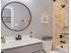 Modern bathroom with vanity, round mirror, and tile shower with tub at 3881 Whisperwood Ct, Youngsville, NC 27596