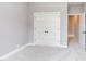 Neutral bedroom showcases a walk-in closet and a doorway to an adjacent room at 3881 Whisperwood Ct, Youngsville, NC 27596