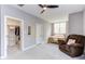 Neutral bedroom with an open closet and cozy recliner for relaxing and reading at 3881 Whisperwood Ct, Youngsville, NC 27596