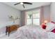 Comfortable bedroom with vintage dresser, quilt bedding, ceiling fan and large window at 3881 Whisperwood Ct, Youngsville, NC 27596