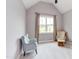 Bedroom with vaulted ceiling features two armchairs and a view of the neighborhood at 3881 Whisperwood Ct, Youngsville, NC 27596