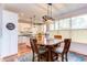 The dining area features a modern chandelier and is adjacent to a bright kitchen at 3881 Whisperwood Ct, Youngsville, NC 27596