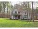 Beautiful two-story home with manicured lawn surrounded by mature trees at 3881 Whisperwood Ct, Youngsville, NC 27596