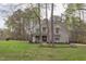 Beautiful two-story home with manicured lawn surrounded by mature trees at 3881 Whisperwood Ct, Youngsville, NC 27596
