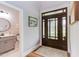 Foyer area featuring decorative front door, tile flooring, and view of a half bathroom at 3881 Whisperwood Ct, Youngsville, NC 27596