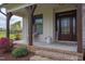 Inviting front porch with brick steps, stone accents, and comfortable seating area at 3881 Whisperwood Ct, Youngsville, NC 27596