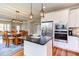 Open-concept kitchen with stainless appliances and a center island that connects to the dining area at 3881 Whisperwood Ct, Youngsville, NC 27596