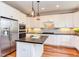 Kitchen boasts stainless steel appliances, a center island, and wooden floors at 3881 Whisperwood Ct, Youngsville, NC 27596