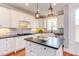 Bright kitchen with white cabinets, contrasting countertops, and stainless steel appliances at 3881 Whisperwood Ct, Youngsville, NC 27596