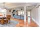 Bright living area with a fireplace, large windows, modern decor, and hardwood flooring at 3881 Whisperwood Ct, Youngsville, NC 27596