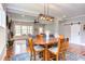 Open concept living and dining area with sliding barn door, wood floors, and modern decor at 3881 Whisperwood Ct, Youngsville, NC 27596