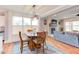 Open concept living and dining area with wood floors and access to the kitchen at 3881 Whisperwood Ct, Youngsville, NC 27596