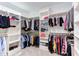Spacious walk-in closet with custom shelving and hanging rods for organized storage at 3881 Whisperwood Ct, Youngsville, NC 27596