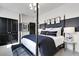 Well-appointed bedroom featuring a four-poster bed with stylish linens, complemented by modern lighting and decor at 4015 Jasper Olive Rd # 30, Apex, NC 27523