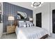 Stylishly decorated bedroom featuring a plaid accent wall, with coordinating linens, modern lighting and an elegant photograph at 4015 Jasper Olive Rd # 30, Apex, NC 27523
