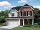 Charming two-story brick home with a well-manicured lawn and a two-car garage, offering classic curb appeal at 4015 Jasper Olive Rd # 30, Apex, NC 27523