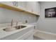 Functional laundry room with white cabinetry and ample counter space and gray walls at 4015 Jasper Olive Rd # 30, Apex, NC 27523