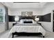 Well-lit main bedroom with unique art and dark colored accent and furniture at 4015 Jasper Olive Rd # 30, Apex, NC 27523