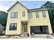 Two-story yellow home with black frame windows and an attached garage under construction at 406 Columbia Dr, Raleigh, NC 27604