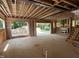 Spacious unfinished living room featuring a fireplace, rough stairs, and sliding doors to the backyard at 406 Columbia Dr, Raleigh, NC 27604