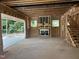 Unfinished open-plan living room and staircase, with a fireplace and natural light at 406 Columbia Dr, Raleigh, NC 27604