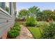 Well-maintained backyard with stone pathway, beautiful landscaping, and greenery at 4769 Swordfish Dr, Raleigh, NC 27603