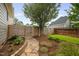 Landscaped backyard featuring a stone path, wooden gate, and lush plantings at 4769 Swordfish Dr, Raleigh, NC 27603