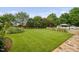 Expansive backyard with a lush lawn, mature trees, and an inviting pool area at 4769 Swordfish Dr, Raleigh, NC 27603