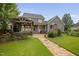 Beautiful backyard featuring a hot tub, gazebo with a grill, a stone patio, and lush greenery at 4769 Swordfish Dr, Raleigh, NC 27603
