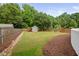 Large backyard featuring a garden shed and lush landscaping at 4769 Swordfish Dr, Raleigh, NC 27603