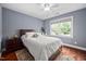 Cozy bedroom with a ceiling fan, a large window, and wood-look flooring at 4769 Swordfish Dr, Raleigh, NC 27603