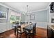 Light-filled dining room with wainscoting, wood floors, and stylish decor at 4769 Swordfish Dr, Raleigh, NC 27603