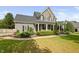 Charming home exterior with a manicured lawn, and inviting front porch with seating at 4769 Swordfish Dr, Raleigh, NC 27603